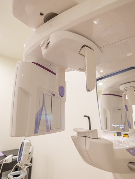 Cone beam scanner standing against a wall in oral surgery office in Houston