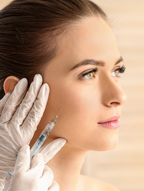 Close up of a woman receiving a BOTOX injection in Houston in her cheek