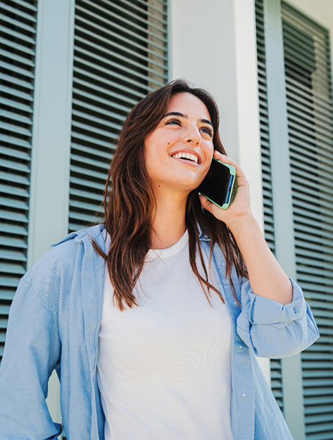 Woman talking on the phone with her oral surgery office in Houston