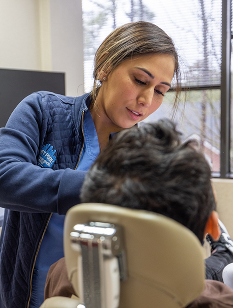 Patient receiving a dental exam before pre prosthetic surgery for dentures in Houston