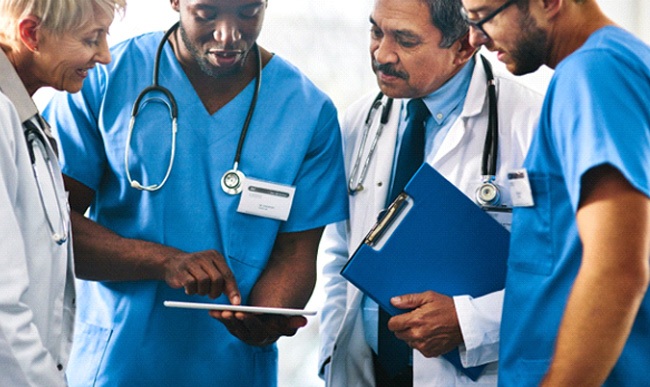 a team of medical professionals looking at a patient’s chart