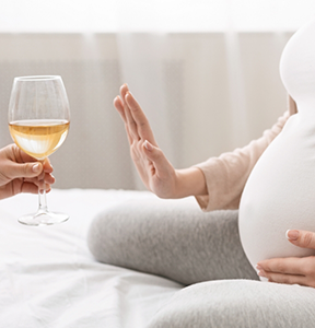 Pregnant person refusing an offer of wine