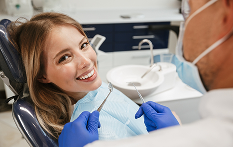Smiling woman getting a dental exam