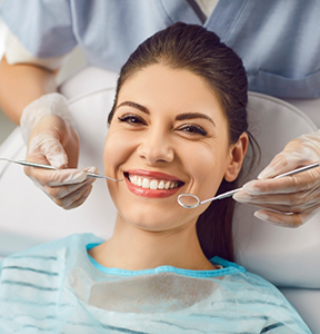 Woman grinning while visiting her dentist for a checkup