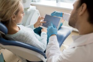 Dentist and patient looking at tablet